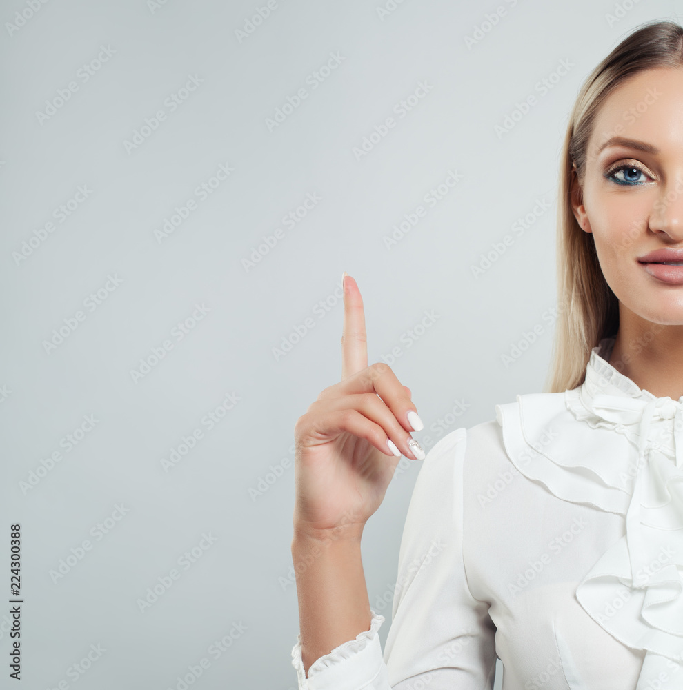 Business woman pointing her finger up on white background with copy space Business woman pointing her finger up on white background with copy space
