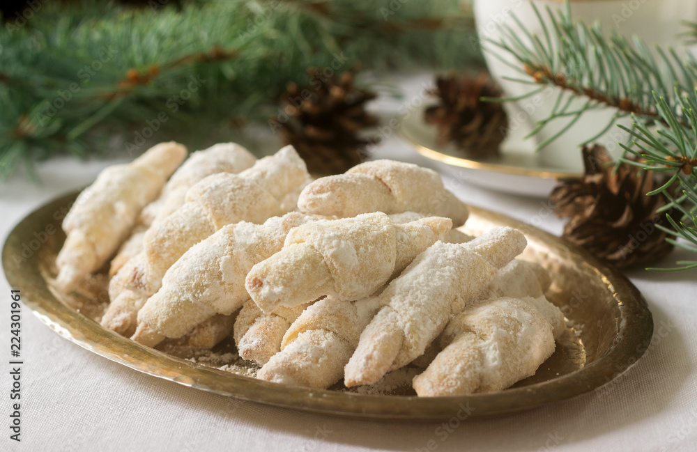 Traditional Romanian or Moldovan shortcake cookies with jam stuffing and a cup of tea on the background of winter decor.