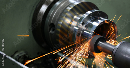 sparks flying while machine griding and finishing metal