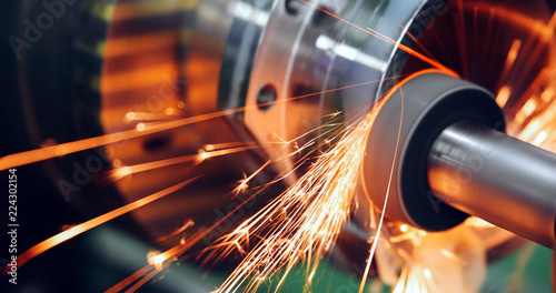sparks flying while machine griding and finishing metal photo