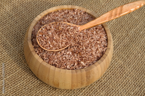 Uzbek red rice for cooking pilaf - devzira in a bamboo bowl