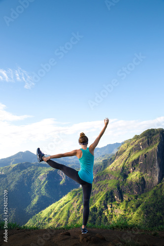 Girl doing yoga in the mountains