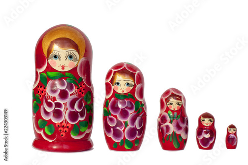Matryoshka Russian doll souvenir in group bright red on white background isolated closeup