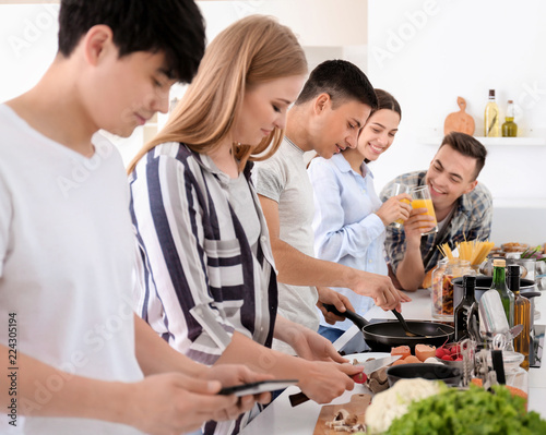 Friends cooking together in...