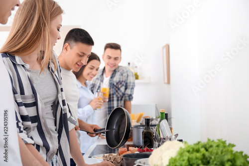 Friends cooking together in...