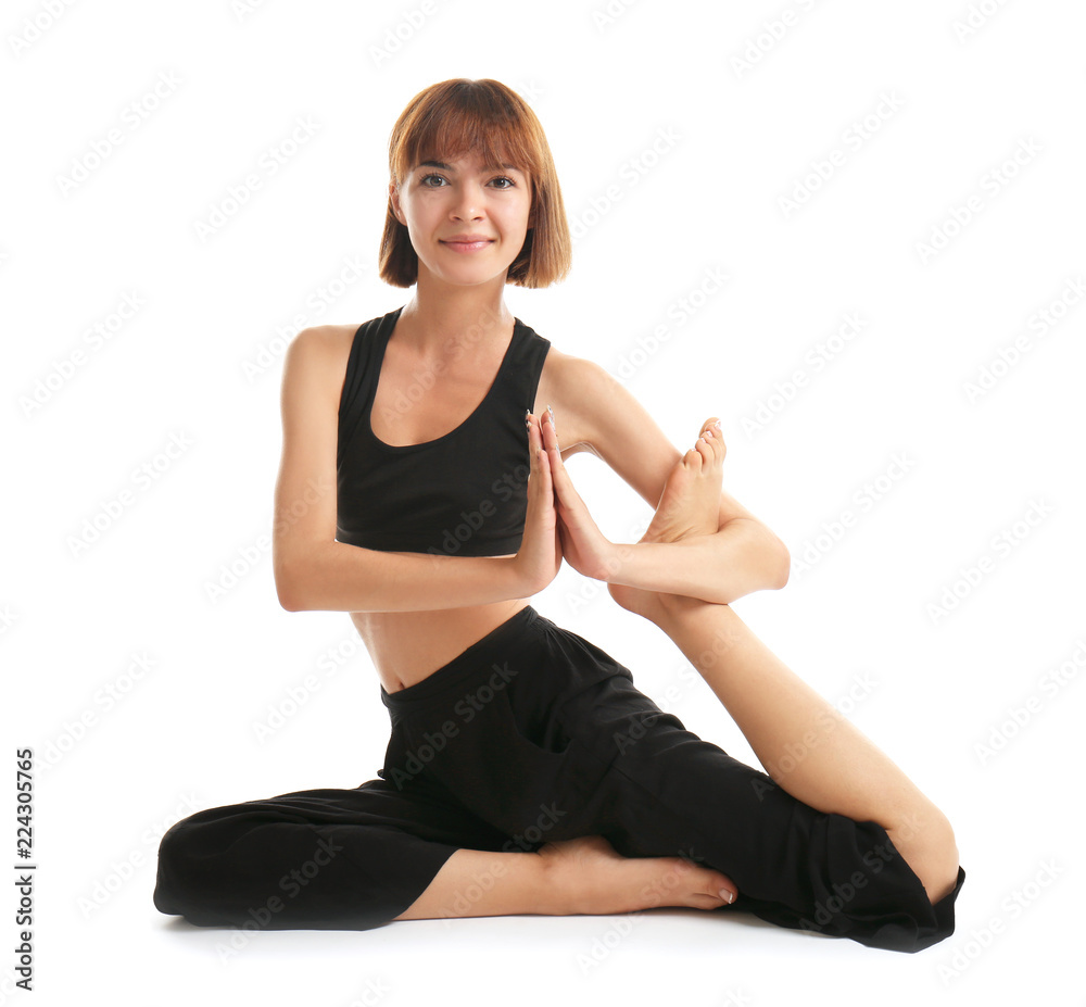 Sporty woman practicing yoga on white background