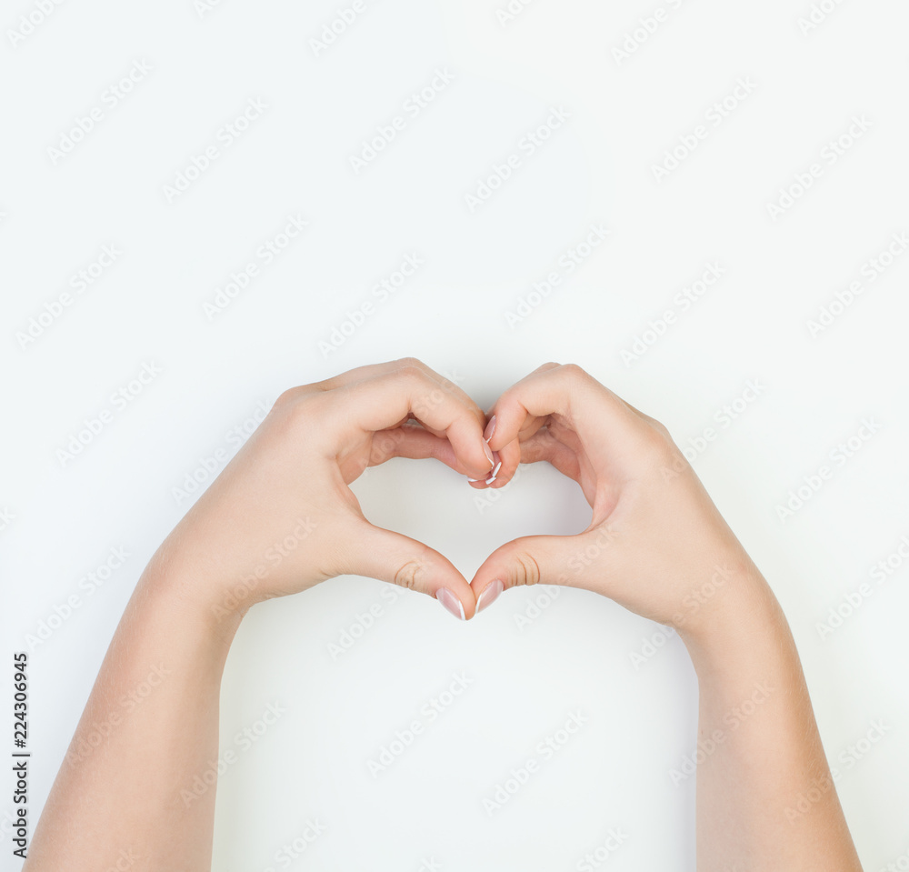 Female hands with heart shape on white background. Manicure concept Female hands with heart shape on white background. Manicure concept