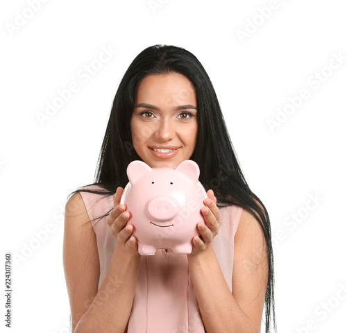 Young woman with piggy bank...