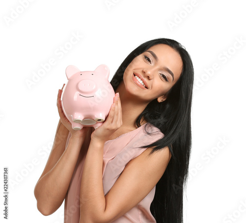 Young woman with piggy bank...