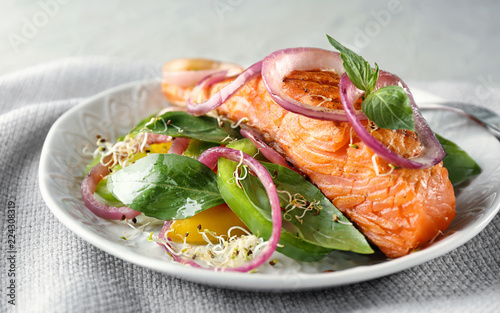 Tasty salmon with salad on plate