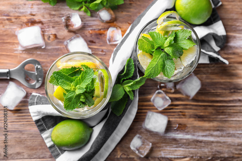 Glasses of fresh mojito on wooden table