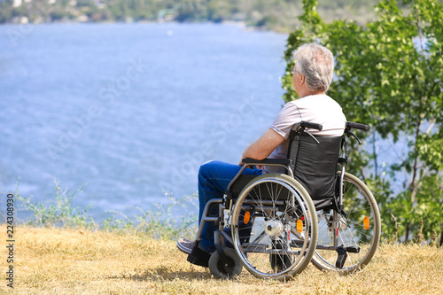 Senior man in wheelchair ne...