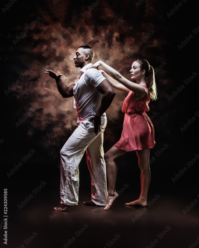 Young and sexy couple dances Caribbean Salsa Young and sexy couple dances Caribbean Salsa