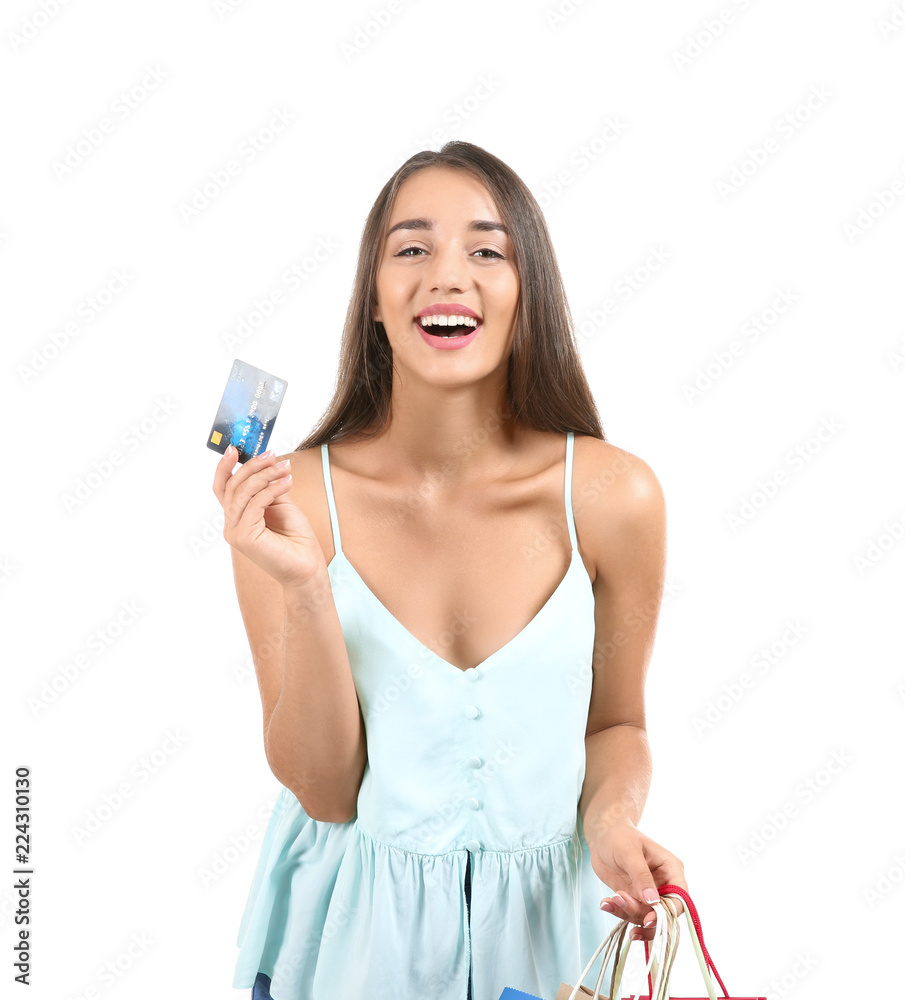 Young woman with shopping bags and credit card on white background Young woman with shopping bags and credit card on white background