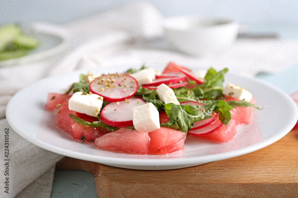 Plate with delicious watermelon salad on table, closeup Plate with delicious watermelon salad on table, closeup
