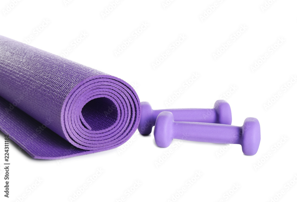 Color yoga mat with dumbbells on white background Color yoga mat with dumbbells on white background