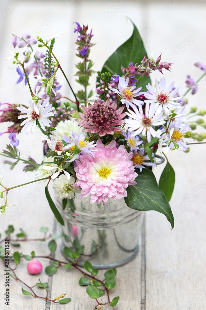 a small bouquet of flowers in pastell colors