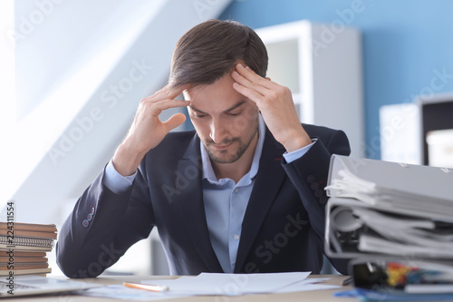 Tired businessman working i...