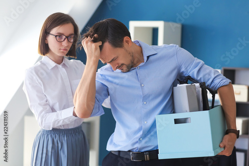 Woman calming fired colleag...