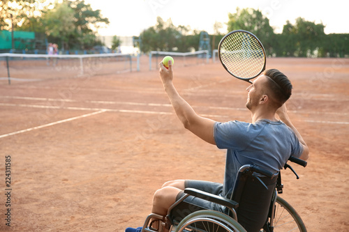 Young man in wheelchair pla...
