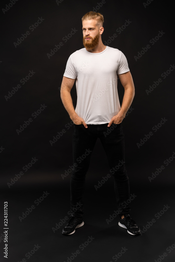 Full length portrait of a happy casual man standing isolated on a gray background. Full length portrait of a happy casual man standing isolated on a gray background.