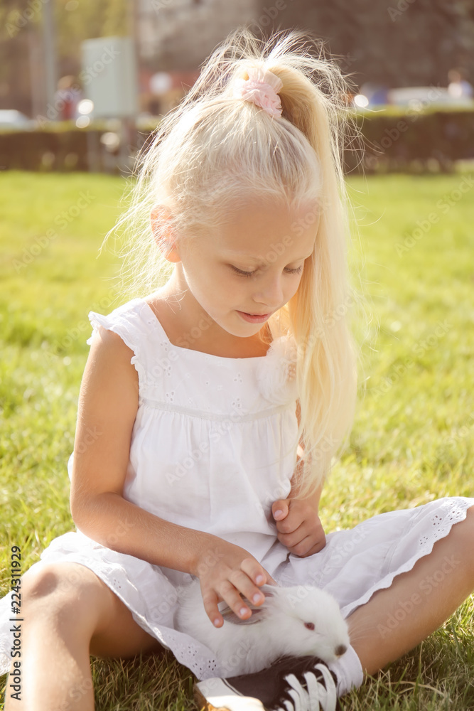 Little girl with cute rabbit outdoors Little girl with cute rabbit outdoors
