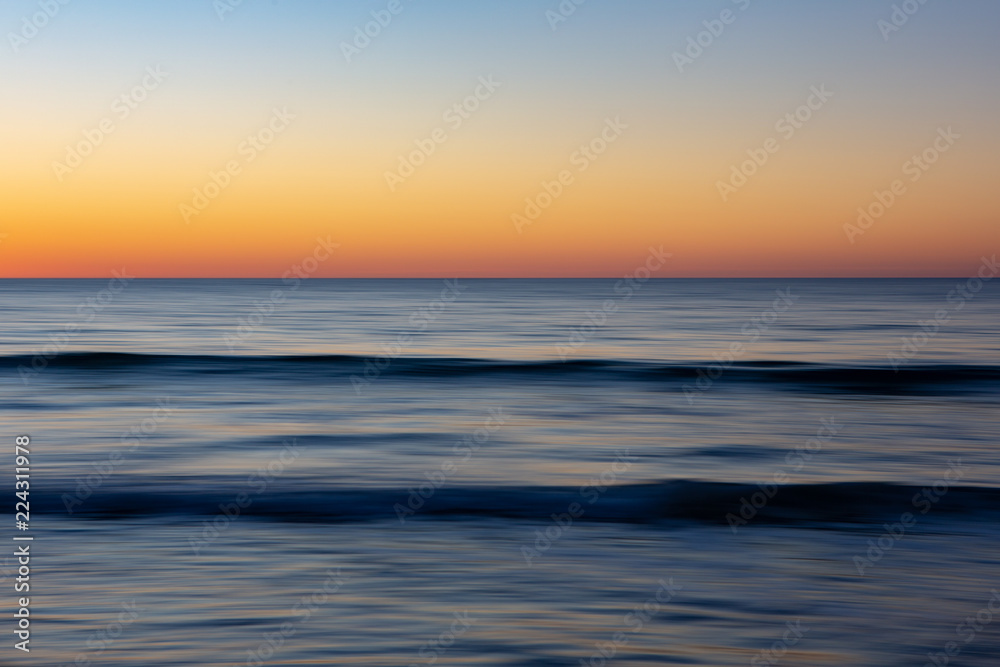 A motion blurred sunset phot of the waves and golden glow from the sun in Port Willunga South Australia on 22nd September 2018 A motion blurred sunset phot of the waves and golden glow from the sun in Port Willunga South Australia on 22nd September 2018