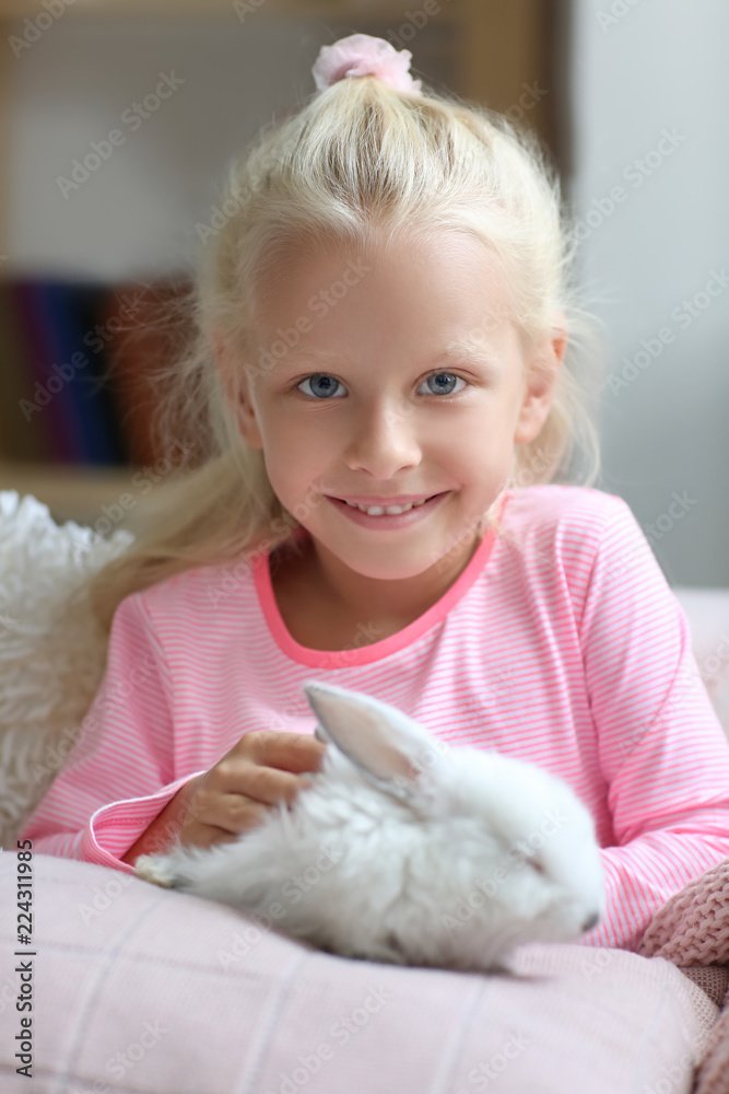 Little girl with cute rabbit at home Little girl with cute rabbit at home