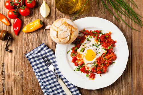 Shakshouka, dish of eggs poached in a sauce of tomatoes, chili peppers, onions
