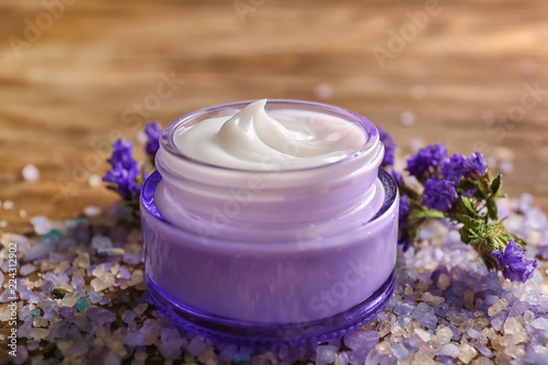 Jar with body cream and sea salt on wooden table © Pixel-Shot