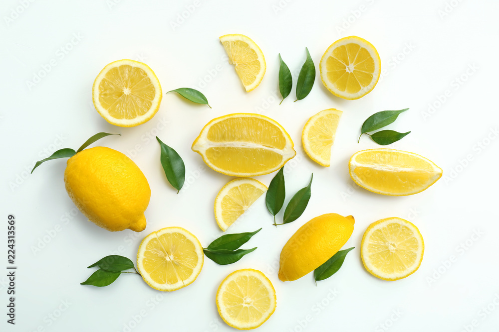 Flat lay composition with ripe juicy lemons on white background