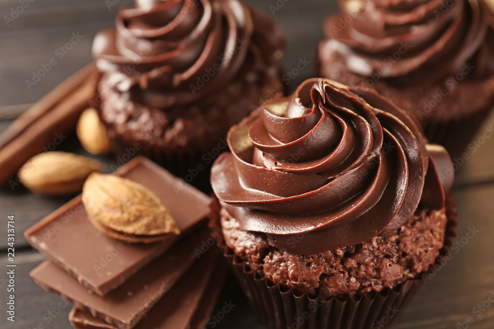 Tasty chocolate cupcakes on wooden table, closeup Tasty chocolate cupcakes on wooden table, closeup