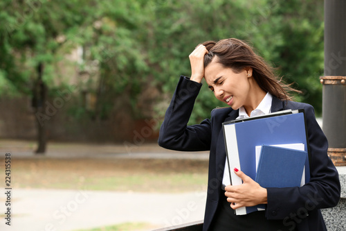 Stressed businesswoman with...