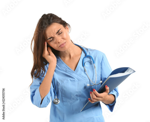 Tired female nurse with fol...