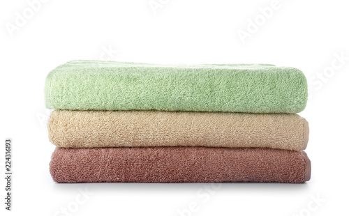 Stack of clean soft towels on white background