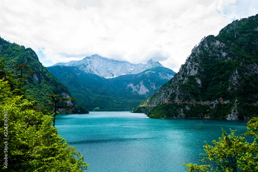landscape of beautiful Piva Lake, mountains and clouds in Montenegro