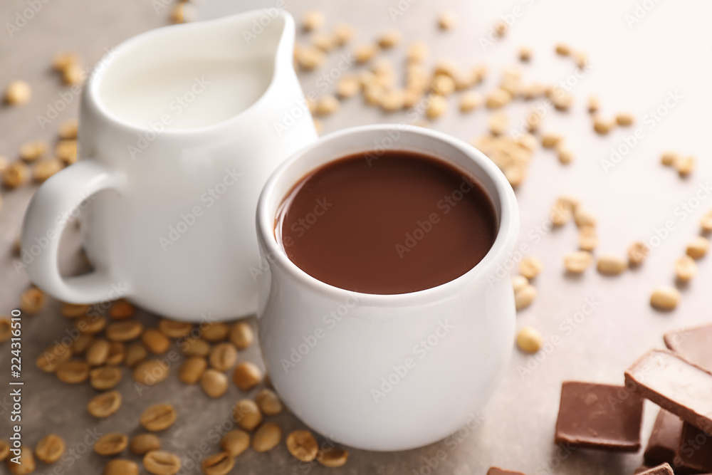Cup of hot chocolate with milk on grey table Cup of hot chocolate with milk on grey table