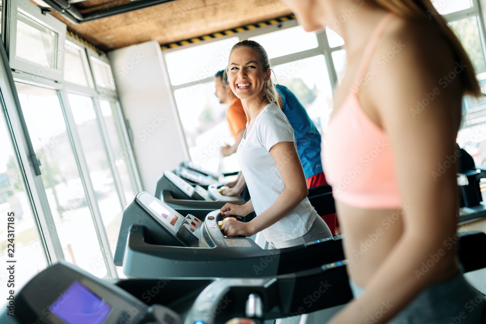 Group of friends exercising on treadmill machine Group of friends exercising on treadmill machine