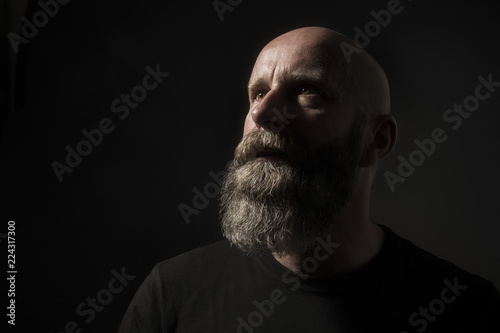 a dark male portrait in classic rembrandt light photo