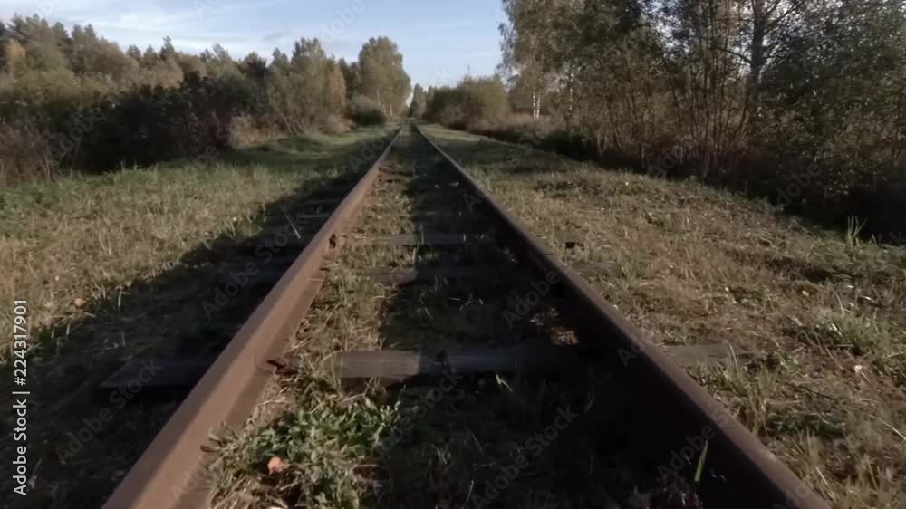 The camera is moving over the old coutryside railway tracks, wide angle perspective point of view The camera is moving over the old coutryside railway tracks, wide angle perspective point of view