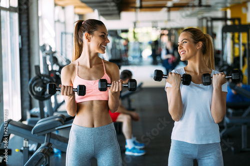 Fototapeta Naklejka Na Ścianę i Meble -  Picture of two fitness women in gym