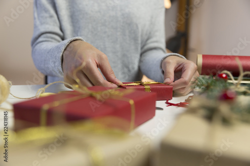 Beautiful women preparing christmas presents. Holiday and christmas concept. Wrapped christmas gifts.