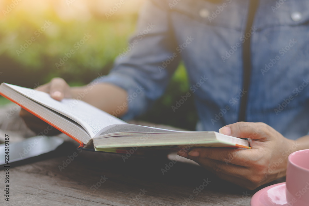 Young woman concentrate on reading book with garden background in free time. Knowledge concept. Young woman concentrate on reading book with garden background in free time. Knowledge concept.