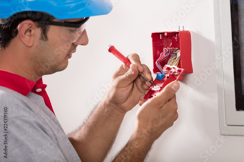 Wallpaper Mural Man installing fire alarm Torontodigital.ca