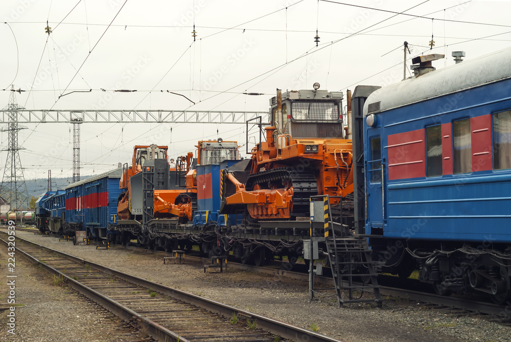 train for accident recovery work with heavy bulldozers on platforms is on the siding train for accident recovery work with heavy bulldozers on platforms is on the siding