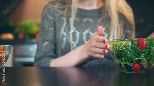 Wallpaper Mural Young lady preferring salad to crisp. Beautiful young woman choosing to eat healthy crisp for supper while sitting at table in stylish kitchen and she eats these salad. Torontodigital.ca