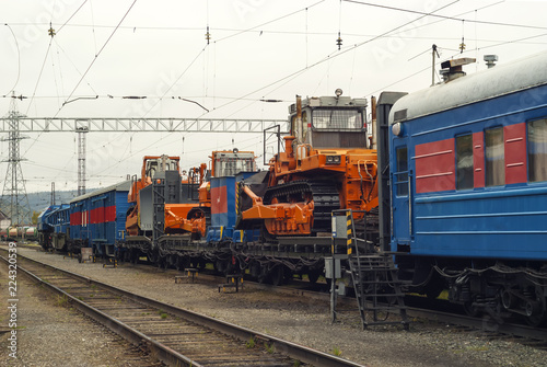train for accident recovery work with heavy bulldozers on platforms is on the siding