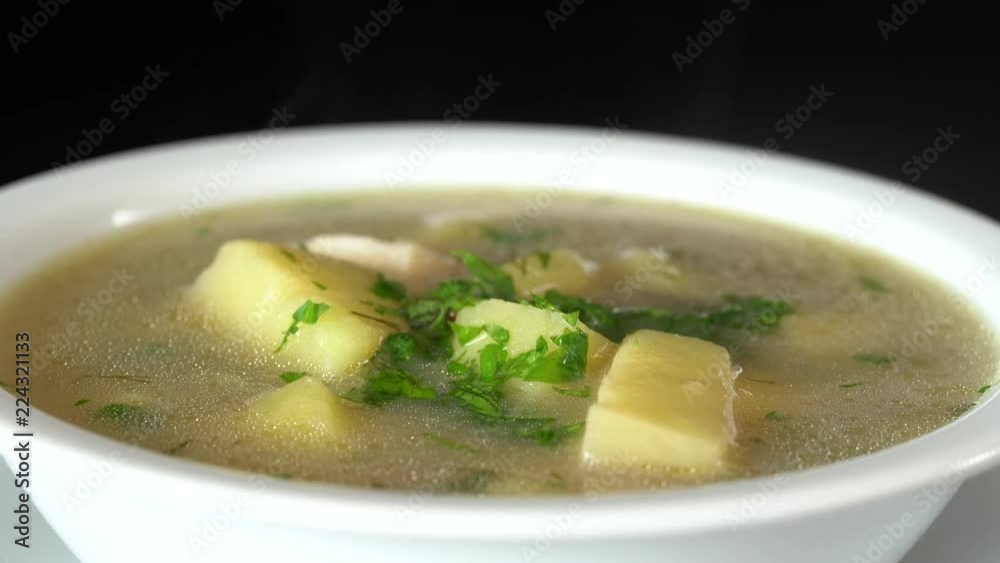 Vegetable soup with mushrooms and potatoes. Healthy food, mushrooms soup in white plate, close up, rotates Vegetable soup with mushrooms and potatoes. Healthy food, mushrooms soup in white plate, close up, rotates
