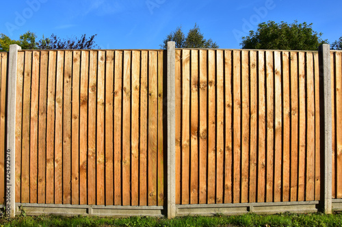 Wooden featheredge garden fence with concrete support posts photo