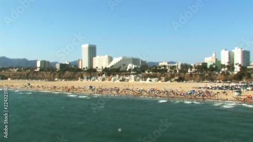 A tilt shift effect miniaturisation timelapse of beach goers at Santa Monica Beach in California.